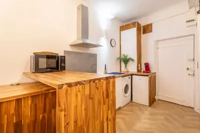 a kitchen with a wooden counter top with a microwave at Charmant T2 centre in Aix-en-Provence
