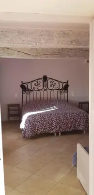 a bedroom with a bed in a room at Le Moulin de Lavon in Gargas