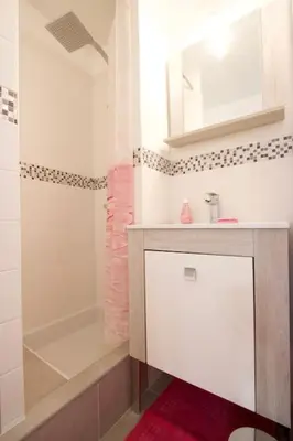 a bathroom with a white sink and a mirror at Le Jourdan clim' terrasse ascenseur garage in Aix-en-Provence