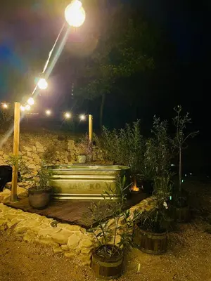 a bench sitting under a street light at night at Histoire de cru in Saignon