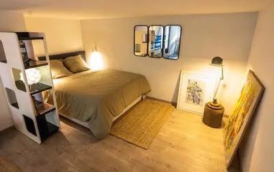 a small bedroom with a bed and a shelf at l'Instant Parfait in Aix-en-Provence