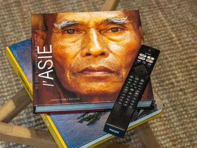 a book with a picture of a man with a remote control at l'Instant Parfait in Aix-en-Provence