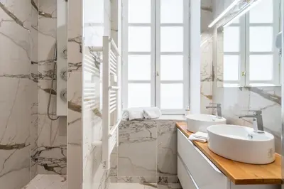 a bathroom with a sink and a window at La Réserve de Salon de Provence in Salon-de-Provence
