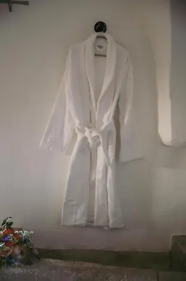 a white robe hanging on a wall at Unique guest room in the heart of Provence 