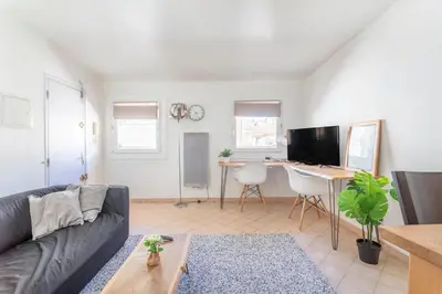 a living room with a couch and a desk at Studio cosy place de la mairie in Aix-en-Provence