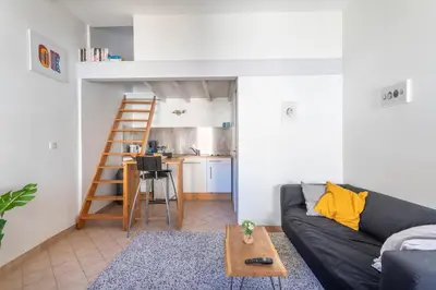 a living room with a couch and a table at Studio cosy place de la mairie in Aix-en-Provence