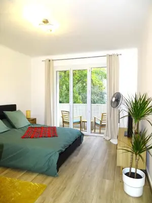 a bedroom with a bed and a large window at TILIA JOURDAN-Studio Cosy Aix Centre-Cours MIRABEAU-PARKING-WIFI-SMART TV-RUE CALME in Aix-en-Provence