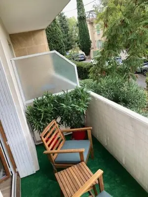 a balcony with two chairs and a cooler at TILIA JOURDAN-Studio Cosy Aix Centre-Cours MIRABEAU-PARKING-WIFI-SMART TV-RUE CALME in Aix-en-Provence