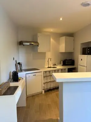 a kitchen with white counters and white cabinets at Gîte Nature en Luberon in Céreste