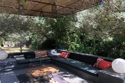 a bedroom with a large bed with a blue blanket at La Matina Family Haven with Olive Garden Oasis in Lauris