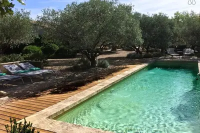 a black couch with pillows and a table at La Matina Family Haven with Olive Garden Oasis in Lauris