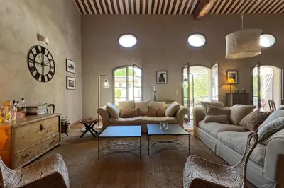 a large kitchen with a wooden table in a room at Maison Marie Provençal Elegance on the Pont Royal Golf Course in Mallemort