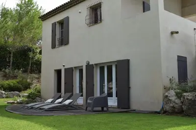 a house with a garden in front of it at Maison Marie Provençal Elegance on the Pont Royal Golf Course in Mallemort