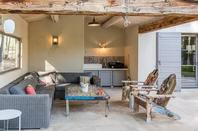 a living room with a couch and a table at Bastide Blanche Villa with swimming pool and pétanque court in Lourmarin in Lourmarin