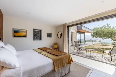 a bedroom with a bed and a large window at Villa Mirage luxury and design in Bonnieux in Bonnieux