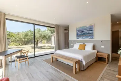 a bedroom with a bed and a desk and a large window at Villa Mirage luxury and design in Bonnieux in Bonnieux