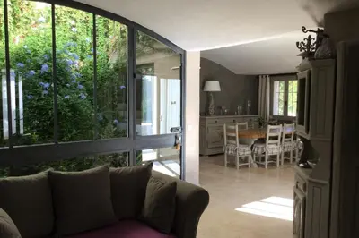 a living room with a couch and a dining room at Villa Maya Large villa and amazing pool in Luberon in Puget