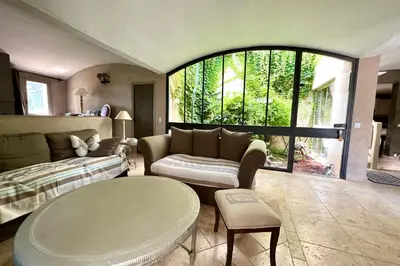a living room with a couch and a table at Villa Maya Large villa and amazing pool in Luberon in Puget