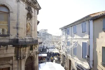 a city street with people walking down the street at Gite les coquelicots ( classé 2* ) Duplex in LʼIsle-sur-la-Sorgue