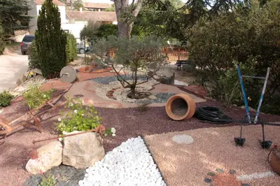 a garden with some plants and tools on the ground at Lou Cigalon in Cabrières-dʼAvignon