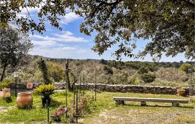 a park bench sitting in the middle of a field at Nice Home In Venasque With Kitchen in Venasque