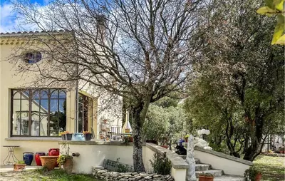 a house with a tree in front of it at Nice Home In Venasque With Kitchen in Venasque