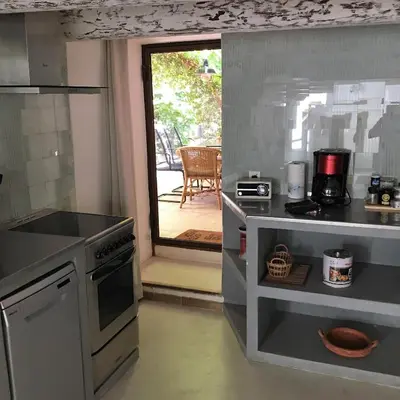 a kitchen with a stove and a counter top at Le Mas du Fort in Gargas