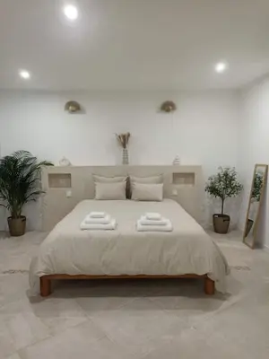 a bedroom with a large bed with two towels on it at La Suite du clocher in Noves