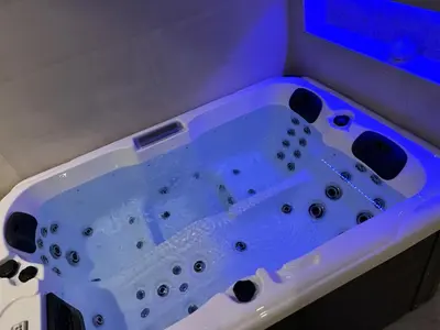 a blue bath tub in a bathroom at La Suite du clocher in Noves