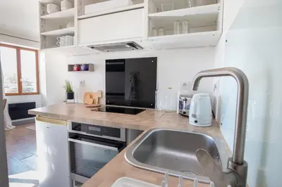 a kitchen with a sink and a counter top at L'Isle en Blanc - 4 couchages - Hypercentre - Clim - Wifi in LʼIsle-sur-la-Sorgue