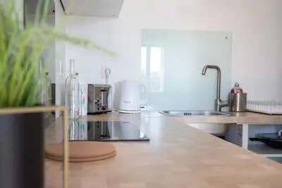 a kitchen with a sink and a counter top at L'Isle en Blanc - 4 couchages - Hypercentre - Clim - Wifi in LʼIsle-sur-la-Sorgue