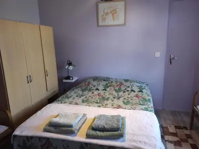 a bedroom with a bed with two towels on it at Au petit Florian en Provence in Apt