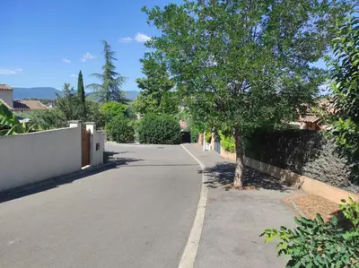 a street with a tree on the side of the road at Au petit Florian en Provence in Apt