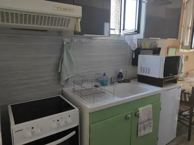 a small kitchen with a sink and a stove at Au petit Florian en Provence in Apt