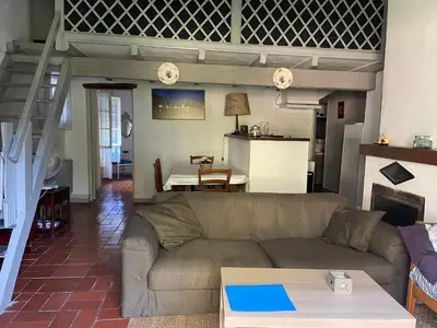 a living room with a couch and a table at Mas Grimaud - Gîte- Studio et chambres d'hôtes familiales in Eygalières