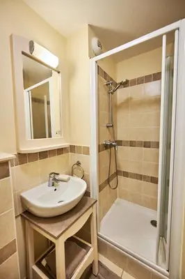 a bathroom with a sink and a shower at Bastidon Golf de Pont Royal in Mallemort