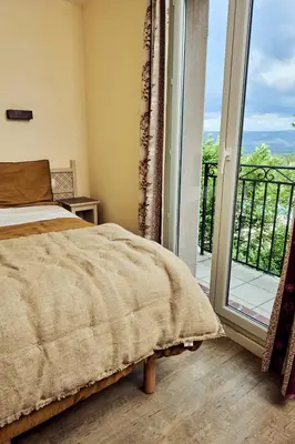 a bedroom with a bed next to a sliding glass door at Bastidon Golf de Pont Royal in Mallemort