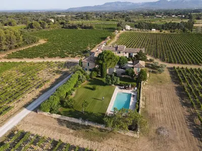 an aerial view of an estate with a swimming pool and vineyards at Auberge de Mazan in Mazan