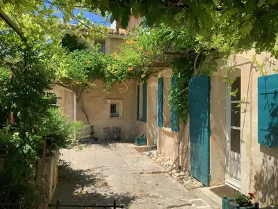 an alley in an old house with trees at Auberge de Mazan in Mazan