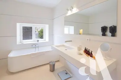 a bedroom with a king sized bed and windows at Mas de L'Amarine in Saint-Rémy-de-Provence