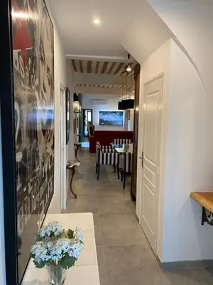 a hallway with a living room and a dining room at La RENAUDIERE in LʼIsle-sur-la-Sorgue
