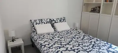 a bedroom with a blue and white bed with two pillows at Aix en Provence - Rotonde - Cours Mirabeau in Aix-en-Provence