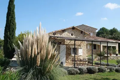 a stone house with a cactus in front of it at Coin de paradis en Provence in Saint-Cannat