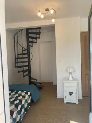a bedroom with a bunk bed and a spiral staircase at Villa avec Pool House au cœur des vignes - Lubéron in La Tour-dʼAigues
