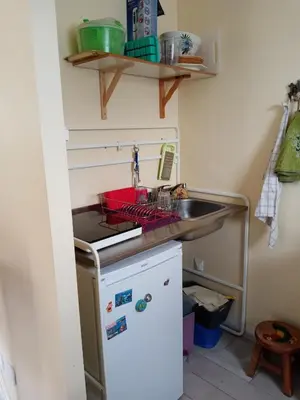 a small kitchen with a sink and a refrigerator at studio Erilys in Apt