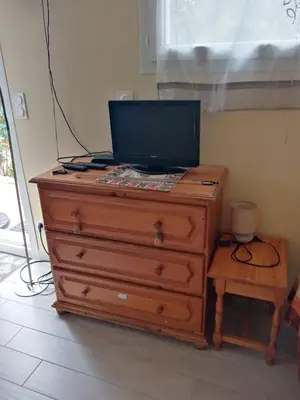 a dresser with a television on top of it at studio Erilys in Apt