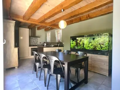 a dining room with a table and a fish tank at B&B 2 Chambres d'hôtes Gai Félibre avec Piscine et Jacuzzi in Le Thor
