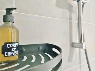 a bottle of soap is sitting in a sink at Grand studio lumineux au calme, centre historique in Pertuis