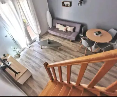 a living room with a couch and a table at Les quatre loges n°2 in Aix-en-Provence