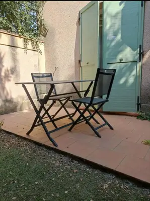 a table and two chairs sitting on a patio at Les quatre loges n°2 in Aix-en-Provence